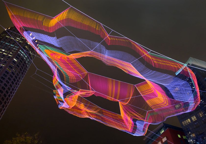 Night shot of "As If It Were Already Here" sculpture by Janet Echelman